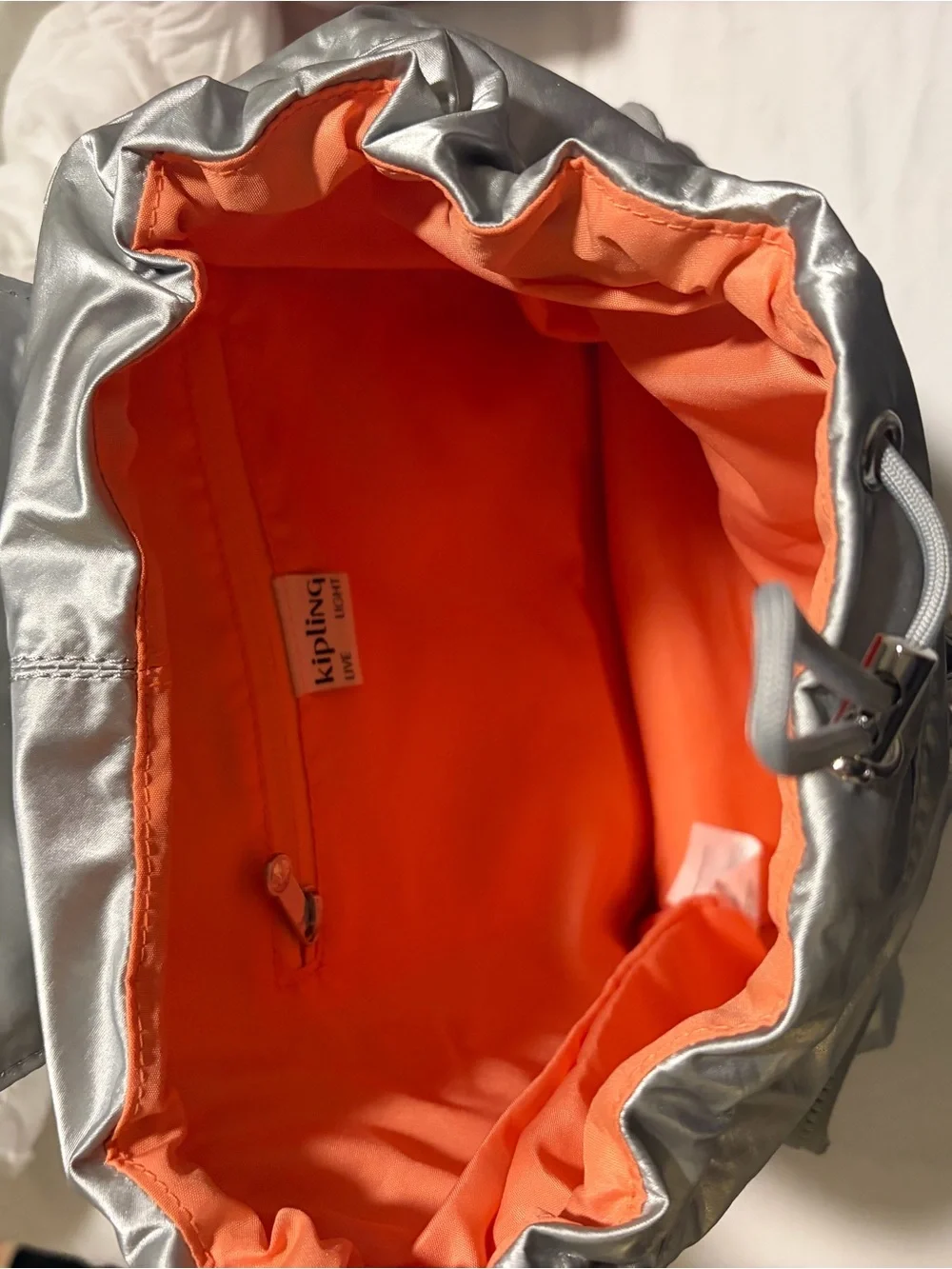 Kipling Silver Metallic Backpack with Orange lining Accent